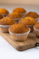 Biscuit muffins close-up. Sweet pastries. Party treat. Dessert on white table - homemade muffins. Portioned cupcakes. Simple muffin