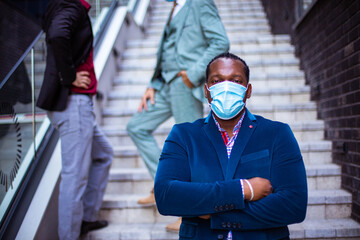 Three business men outside. Portrait of senior man. Focus is on foreground.