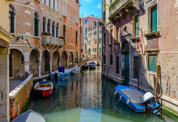 Obraz na płótnie Canvas Narrow canal with bridge in Venice, Italy. Architecture and landmark of Venice. Cozy cityscape of Venice.