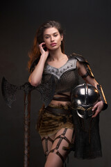 Obraz na płótnie Canvas Studio shot of wild woman viking holding axe