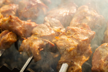Shish Kebab made from pieces of pork is cooked on skewers on the grill