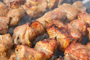 Shish Kebab made from pieces of pork is cooked on skewers on the grill