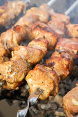 Shish Kebab made from pieces of pork is cooked on skewers on the grill