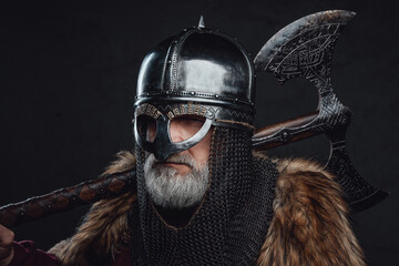 Studio shot of old age templar holding axe