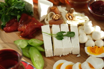Delicious traditional turkish breakfast on yellow checkered tablecloth.
Tea, olives, eggs, cheeses, cucumbers, tomatoes,
French fries and peppers