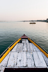 Wooden boat sailing on the River Ganges in Varanasi, India