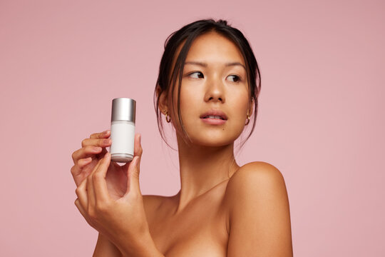 Beautiful Asian Woman Holding Beauty Care Product