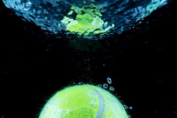 Tennis ball in water Splashing water dropletssoft focus.