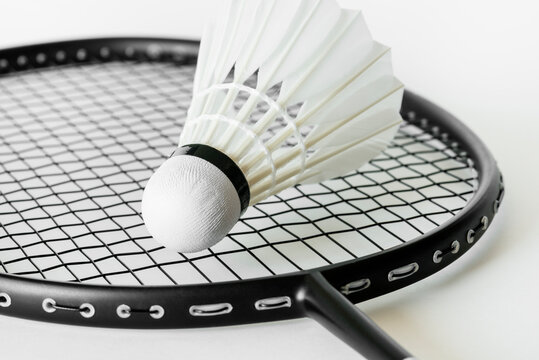 Closeup of shuttlecock with a badminton racket