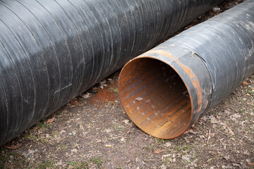 Replacement of the sewer pipeline within the city limits. On the ground are two new pipes,...