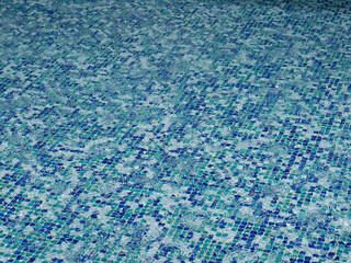 Poolside in the rain. The bottom is covered with tiles.