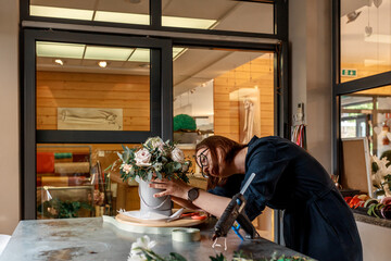 Organizer of weddings forms composition in flower box for decoration at celebration. Original decor concept