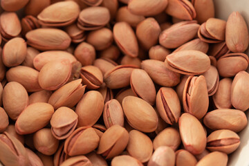 Siirt peanuts in white bowl on fabric.