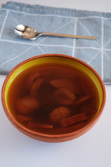 Compote in ceramic bowl on wooden stand.Delicious healthy compote made from dried fruits.
Apricot in spoon