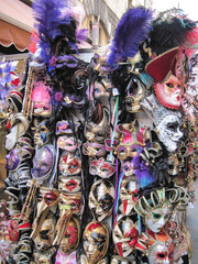 Beautiful woman carnival masks. Traditional Venetian souvenir gifts of tourist people. Colorful handmade masks in bright red, blue and gold colors.

