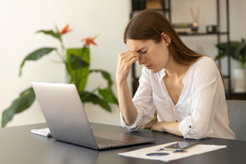 Frustrated millennial caucasian freelancer woman overworked by computer feel headache migraine...