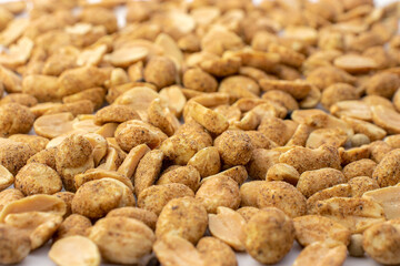 A lot of nuts in a close-up, a lot of spicy nuts with pepper, a background of nuts