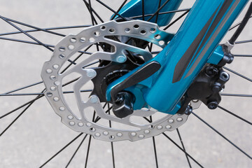 Front disk brake of bicycle, close-up in selective focus