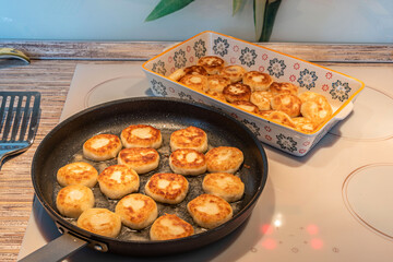 Cheesecakes or Syrniki on a pan. Russian and Ukrainian Cuisine