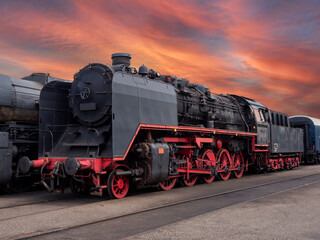 Historical locomotive with dramatic cloudy sky in abandoned industrial area
