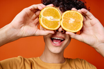Cheerful guy with curly orange hair near the eyes close-up Studio