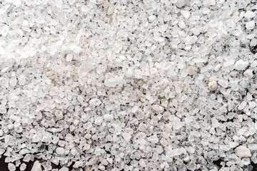 selective focus. food background. coarse sea salt in crystals. white color, stone. top view, with deep shadows. texture. macro, copyspace