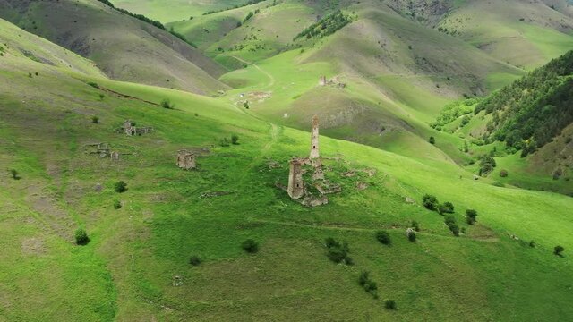 Aerial around view of medieval tower complex in the mountains of Ingushetia, Russia, 4k