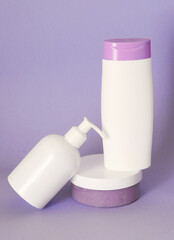 Group of cosmetic bottles on colorful background.