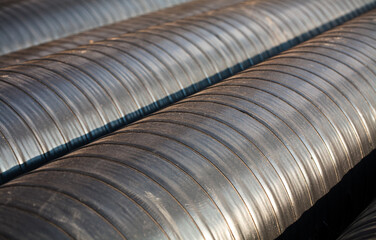 New pre-insulated pipes with anti-corrosive protective tape, ready for welding.