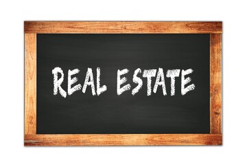 Fototapeta premium REAL ESTATE text written on wooden frame school blackboard.