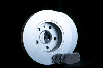 Auto valve. Motor mechanic spare or automotive piece isolated on black background. New metal car part. Flat lay, top view, copy space.