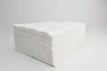 Stack of paper tissues on white background. Big stack of white paper napkins, close up. White...