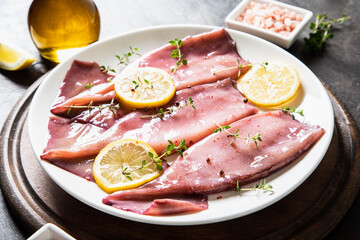 fresh squids octopus or cuttlefish for cooked food. Fresh raw cuttlefish. Raw squid with lemon. Top view and copy space for your text.