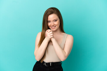 Teenager girl over isolated blue background laughing