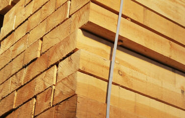 Wooden boards stacked outdoors. Lumber warehouse.