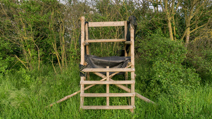 Lookout wooden ladder seat, also known as hunter's seat, hunter's high seat between the trees in...