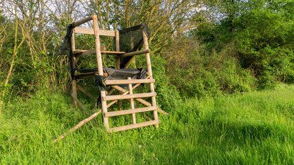 Lookout wooden ladder seat, also known as hunter's seat, hunter's high seat between the trees in...