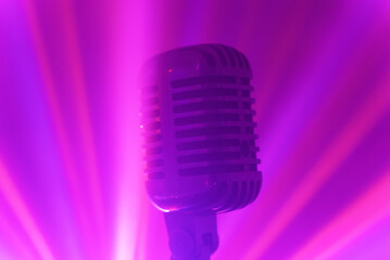 Vintage microphone with stage disco lights. Live performance or karaoke concept.