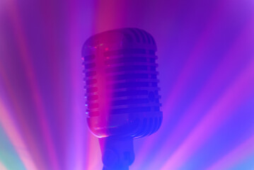 Fototapeta na wymiar Vintage microphone with stage disco lights. Live performance or karaoke concept.