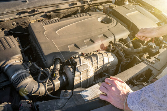 Engine problem. Driver man near open hood vehicle broken down on road. Auto motor car problem concept. - Powered by Adobe