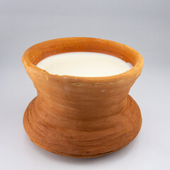 A Traditional clay pot of curd or yogurtA Traditional clay pot of curd or yogurt placed on coconut...