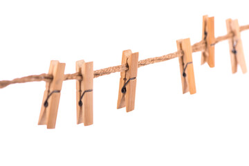 Clothespins with the rope on a white background