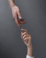 the girl's hand touches the man's hand
