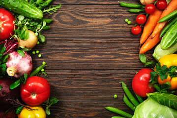 Healthy food. Assortment of fresh summer organic vegetables and herbs on wooden table background