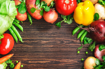 Healthy food. Assortment of fresh summer organic vegetables and herbs on wooden table background