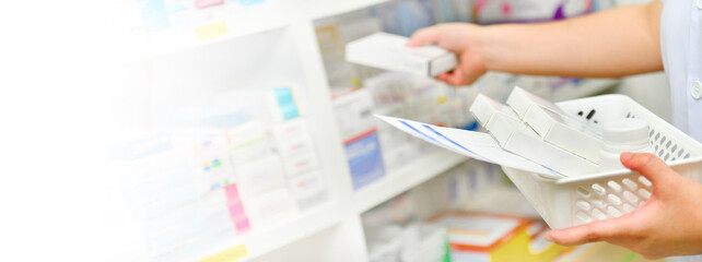Pharmacist filling prescription in pharmacy drugstore ,free space on left side for text.	