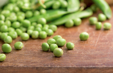 Green pea on rustic wooden background with copy space, natural wooden table.