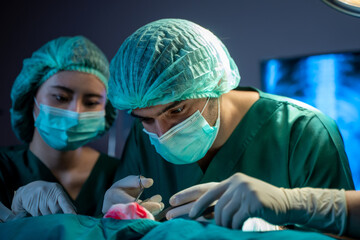 Medical team performing operation.,Diverse team of professional surgeon and nurses performing surgery on a patient in the hospital operating room.
