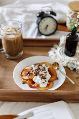 Pancakes with peaches, blueberries and banana in a cozy setting 
