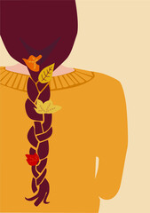 Autumn leaves are woven into a girl's braid. Women's braid.